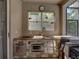 An outdoor stone kitchen features a grill and storage at 6107 Ibispark Dr, Lithia, FL 33547