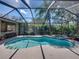 Inviting screened-in pool with spa and bar provides a delightful setting for outdoor gatherings and relaxation at 6107 Ibispark Dr, Lithia, FL 33547