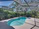 Sparkling pool with jacuzzi offers a private, screened oasis with lush tropical landscaping and a spacious patio area at 6107 Ibispark Dr, Lithia, FL 33547