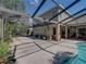 Generous screened-in pool patio offers versatile space for relaxation and entertainment alongside the pool at 6107 Ibispark Dr, Lithia, FL 33547