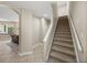 Carpeted staircase featuring neutral colored walls and tile flooring at 6107 Ibispark Dr, Lithia, FL 33547