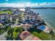 Aerial view of a waterfront condo community with a sparkling pool and well-manicured lawns at 6177 Sun Blvd # 302, St Petersburg, FL 33715