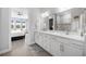 Bright bathroom with double sink vanity, a large mirror, and modern fixtures at 6218 Mooring Line Cir, Apollo Beach, FL 33572