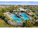 Community pool and splash pad areas feature lush landscaping, seating, and shade with views of community beyond at 6218 Mooring Line Cir, Apollo Beach, FL 33572