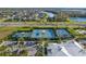 Aerial shot of tennis and basketball courts near a community clubhouse, set amongst lush landscaping at 6218 Mooring Line Cir, Apollo Beach, FL 33572