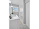 Renovated bathroom featuring a walk-in shower and a white vanity with marble countertop at 6300 6Th N Ave, St Petersburg, FL 33710