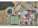 An aerial view of the community with a pool, tennis court, playground, and parking at 7459 Oxford Garden Cir, Apollo Beach, FL 33572