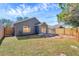 Spacious backyard with a new privacy fence and a well-maintained lawn, perfect for outdoor activities and relaxation at 7459 Oxford Garden Cir, Apollo Beach, FL 33572