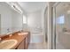 A spacious bathroom with dual sinks, bathtub and glass shower enclosure at 7459 Oxford Garden Cir, Apollo Beach, FL 33572