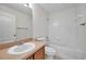 Clean bathroom with single sink vanity, tile shower, and bathtub at 7459 Oxford Garden Cir, Apollo Beach, FL 33572