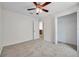 Comfortable carpeted bedroom with ceiling fan and closet at 7459 Oxford Garden Cir, Apollo Beach, FL 33572