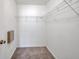 Walk-in closet with neutral carpet and wire rack shelving at 7459 Oxford Garden Cir, Apollo Beach, FL 33572