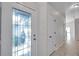 Inviting foyer with a decorative glass front door, neutral paint, and tile flooring, creating a bright and welcoming entrance at 7459 Oxford Garden Cir, Apollo Beach, FL 33572