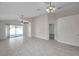 Bright living room featuring tile flooring, ceiling fan, and sliding glass doors to the exterior at 7459 Oxford Garden Cir, Apollo Beach, FL 33572