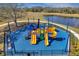 Community playground featuring multiple slides, climbing structures, and a soft, colorful play surface at 7459 Oxford Garden Cir, Apollo Beach, FL 33572