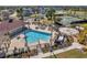 Community pool featuring lounge seating, a splash pad, and tennis courts, surrounded by lush landscaping at 7459 Oxford Garden Cir, Apollo Beach, FL 33572