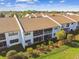 Aerial view of multiple condo units featuring screened patios, well-manicured lawns, and fenced yards at 7623 Radcliffe Cir # 112A, Port Richey, FL 34668