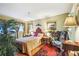 Cozy bedroom featuring a comfortable bed, wood floors, and ample natural light at 7623 Radcliffe Cir # 112A, Port Richey, FL 34668