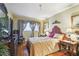 Serene bedroom with a detailed headboard, bedside tables, and hardwood floors at 7623 Radcliffe Cir # 112A, Port Richey, FL 34668