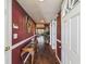 Inviting hallway with hardwood floors, decor, and an open view to the living area at 7623 Radcliffe Cir # 112A, Port Richey, FL 34668