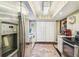Bright kitchen featuring stainless steel appliances, wood floors, and a decorative chandelier at 7623 Radcliffe Cir # 112A, Port Richey, FL 34668