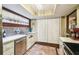 Cozy kitchen with stainless steel dishwasher, silver backsplash, and white countertops at 7623 Radcliffe Cir # 112A, Port Richey, FL 34668