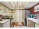 Bright kitchenette area featuring stainless steel appliances, lighting and storage space at 7623 Radcliffe Cir # 112A, Port Richey, FL 34668