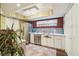 Bright kitchenette area featuring stainless steel appliances, cabinetry, and decor at 7623 Radcliffe Cir # 112A, Port Richey, FL 34668