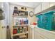 Laundry room with a washer, dryer, shelving, and various cleaning supplies at 7623 Radcliffe Cir # 112A, Port Richey, FL 34668