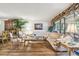 Inviting living room featuring wood floors, comfortable seating, and large windows with elegant drapery at 7623 Radcliffe Cir # 112A, Port Richey, FL 34668