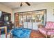 Bright sunroom featuring comfortable seating, a blue rug, and large sliding glass doors to the outside at 7623 Radcliffe Cir # 112A, Port Richey, FL 34668
