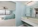 Open bathroom, through bedroom, features sleek fixtures and a bright interior at 7700 Sun Island S Dr # 608, South Pasadena, FL 33707