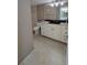 Well-lit bathroom with tile floors, white cabinets, and a black countertop at 7700 Sun Island S Dr # 608, South Pasadena, FL 33707