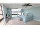 Serene bedroom features soft blue walls, carpet, and scenic water view from its large picture window at 7700 Sun Island S Dr # 608, South Pasadena, FL 33707