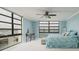 Bright bedroom with views of the water through large windows, featuring light blue walls, and neutral decor at 7700 Sun Island S Dr # 608, South Pasadena, FL 33707