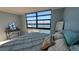 Bright bedroom offers great natural light, soft blue walls, and amazing views of the water at 7700 Sun Island S Dr # 608, South Pasadena, FL 33707