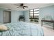Cozy bedroom with light blue walls, soft carpet, and a large window providing lots of natural light at 7700 Sun Island S Dr # 608, South Pasadena, FL 33707
