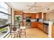Bright kitchen features wooden cabinets, stainless steel appliances, and lovely views from the window at 7700 Sun Island S Dr # 608, South Pasadena, FL 33707