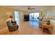 Cozy living room featuring wood floors, ceiling fan, and access to a private outdoor balcony at 7700 Sun Island S Dr # 608, South Pasadena, FL 33707