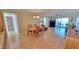 Open floor plan living and dining area with wood floors and a sliding glass door to the balcony at 7700 Sun Island S Dr # 608, South Pasadena, FL 33707