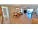 Open-concept living and dining area with water views and access to balcony and light hardwood flooring at 7700 Sun Island S Dr # 608, South Pasadena, FL 33707