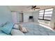 Bright main bedroom featuring a ceiling fan, large windows, and soft, cozy carpeting at 7700 Sun Island S Dr # 608, South Pasadena, FL 33707