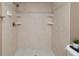 Close up of a bathroom shower featuring tiled walls and built-in shelving at 7700 Sun Island S Dr # 608, South Pasadena, FL 33707