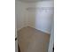 Empty carpeted walk-in closet with a single metal clothing rack, providing ample storage space at 7700 Sun Island S Dr # 608, South Pasadena, FL 33707