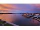Scenic waterfront view featuring a bay, condos, and lush landscaping under a dramatic sky at 7700 Sun Island S Dr # 608, South Pasadena, FL 33707