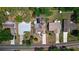 Aerial shot of a home showcasing it's proximity to nearby homes, mature trees, lawn and street access at 834 Riverside Dr, Tarpon Springs, FL 34689