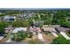 Aerial view of the home with lush landscaping, well-maintained lawn, and neighborhood at 834 Riverside Dr, Tarpon Springs, FL 34689