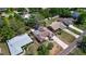 Overhead view of home showing mature trees, lush lawn, deck, shed and proximity to neighbors at 834 Riverside Dr, Tarpon Springs, FL 34689