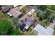 Aerial view of a well-maintained home with mature landscaping and a unique, geometrically designed roof at 834 Riverside Dr, Tarpon Springs, FL 34689