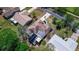 Aerial view of a well-maintained home with mature landscaping and a unique, geometrically designed roof at 834 Riverside Dr, Tarpon Springs, FL 34689
